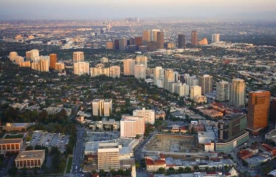 Aerial view of Beverly Hills with Wilshire Blvd in the foreground and Santa Monica Blvd, Los Angeles, California.